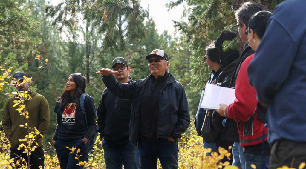 Elder on the land teaching others about good fire.