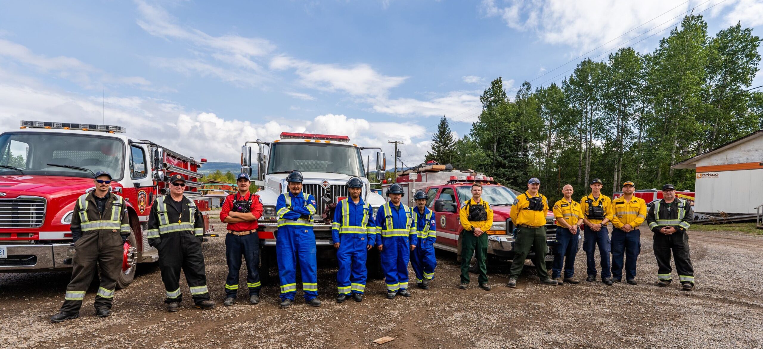 the structural defense task force standing outside their firefighting vehicles
