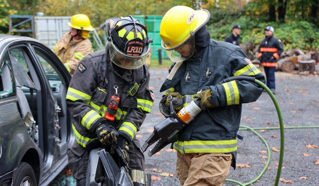 A student learning how to use the jaws of life.