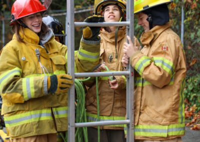 youth learning how to use extension ladder.