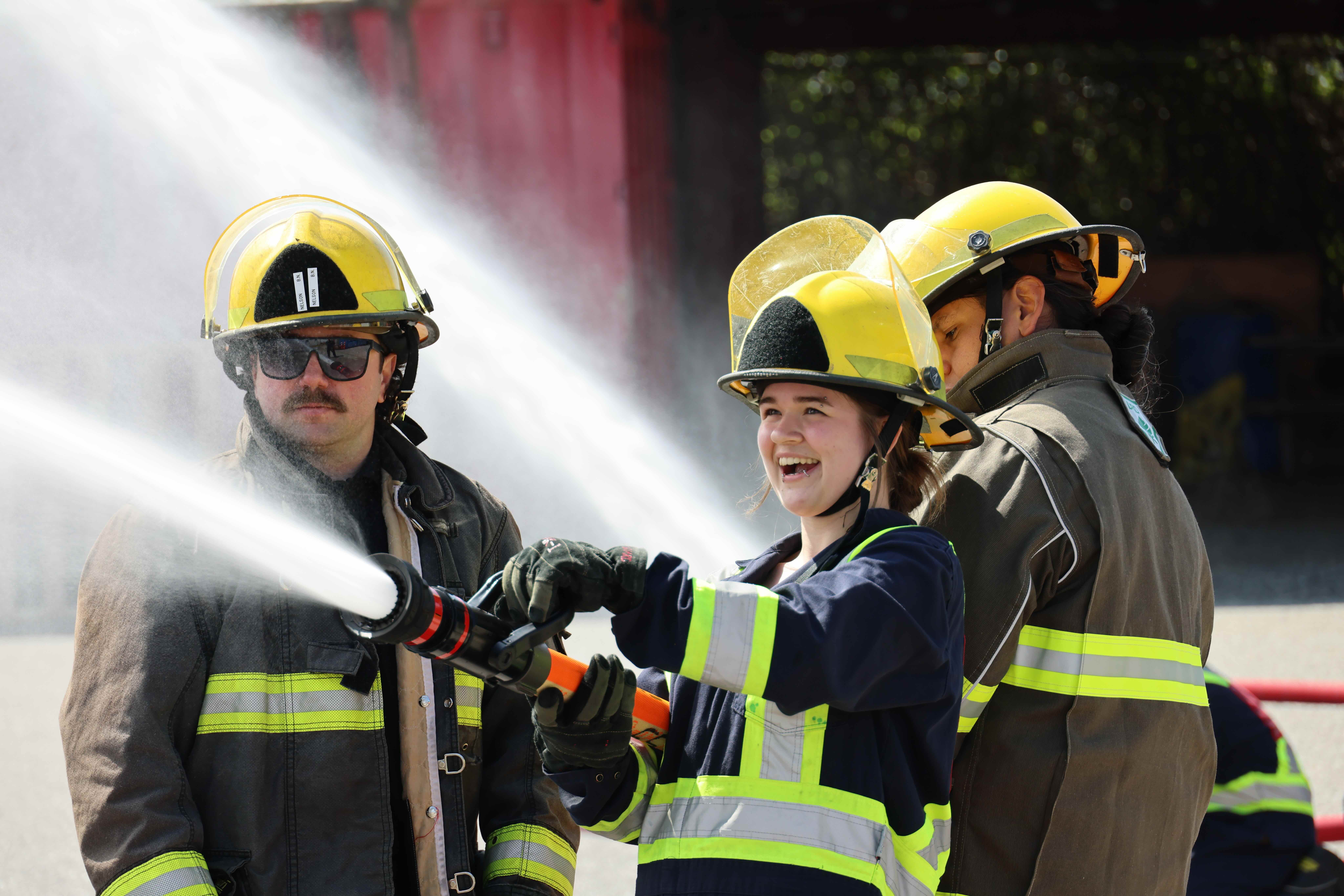 youth smiling holding fire house