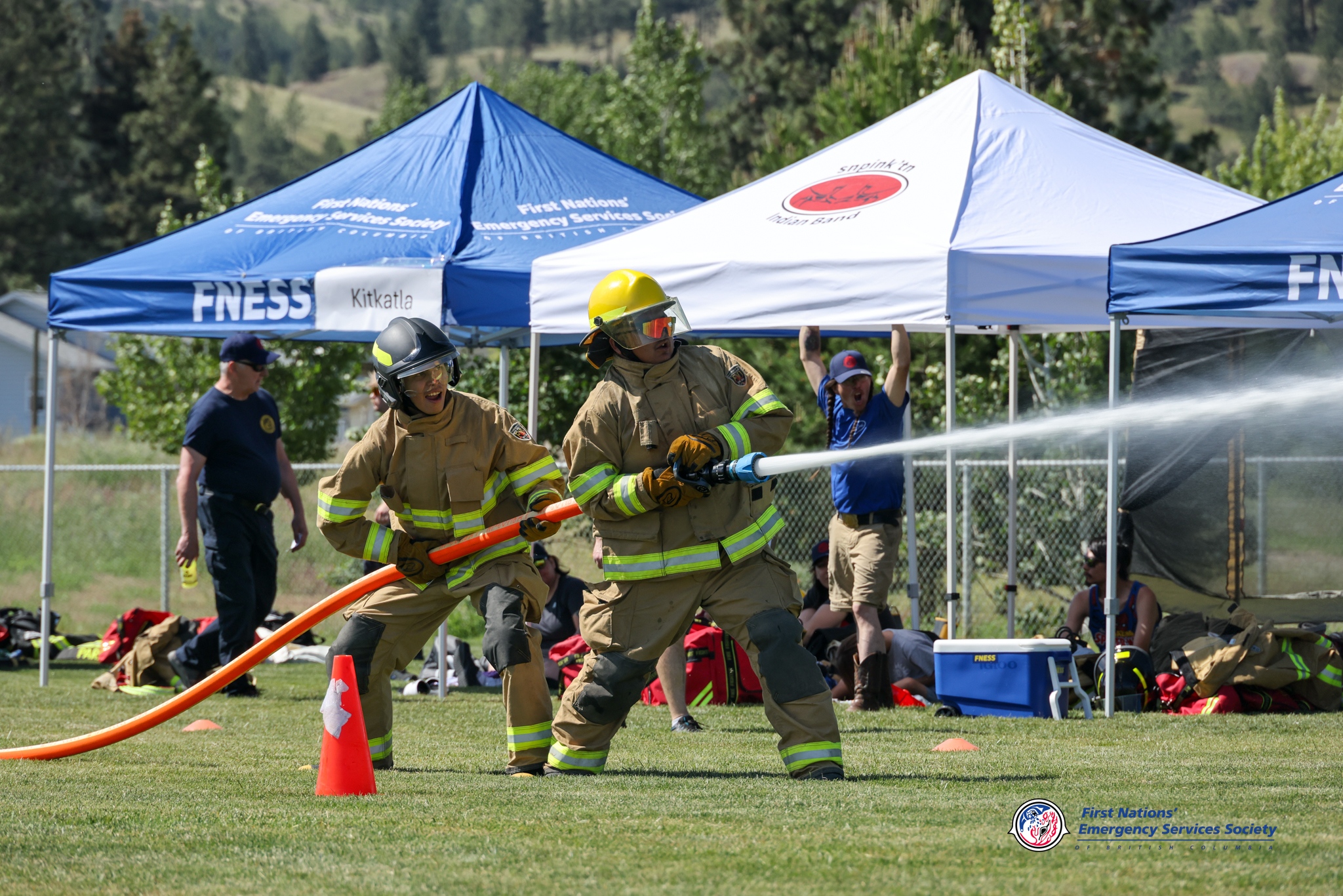 competition firefighters with fire hose